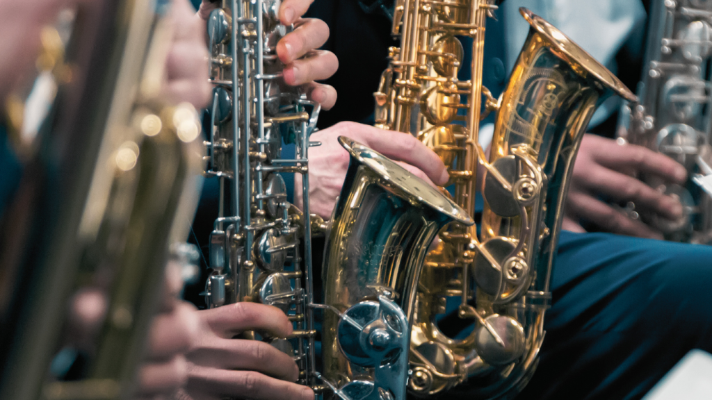 close up photo of students playing saxophones