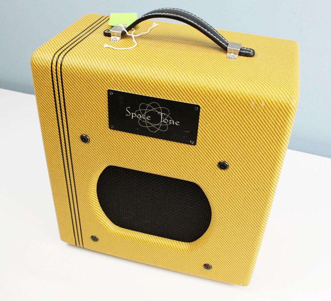 Angled front-left view of the Swart Space Tone Atomic Jr highlighting the tweed finish and finger-jointed pine cabinet.