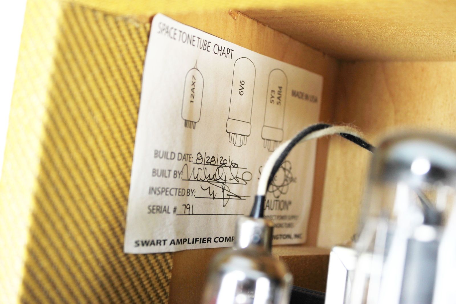 Close-up of the vacuum tubes including JJ 12AX7, JJ 6V6GT, and GZ-34 rectifier inside the cabinet.