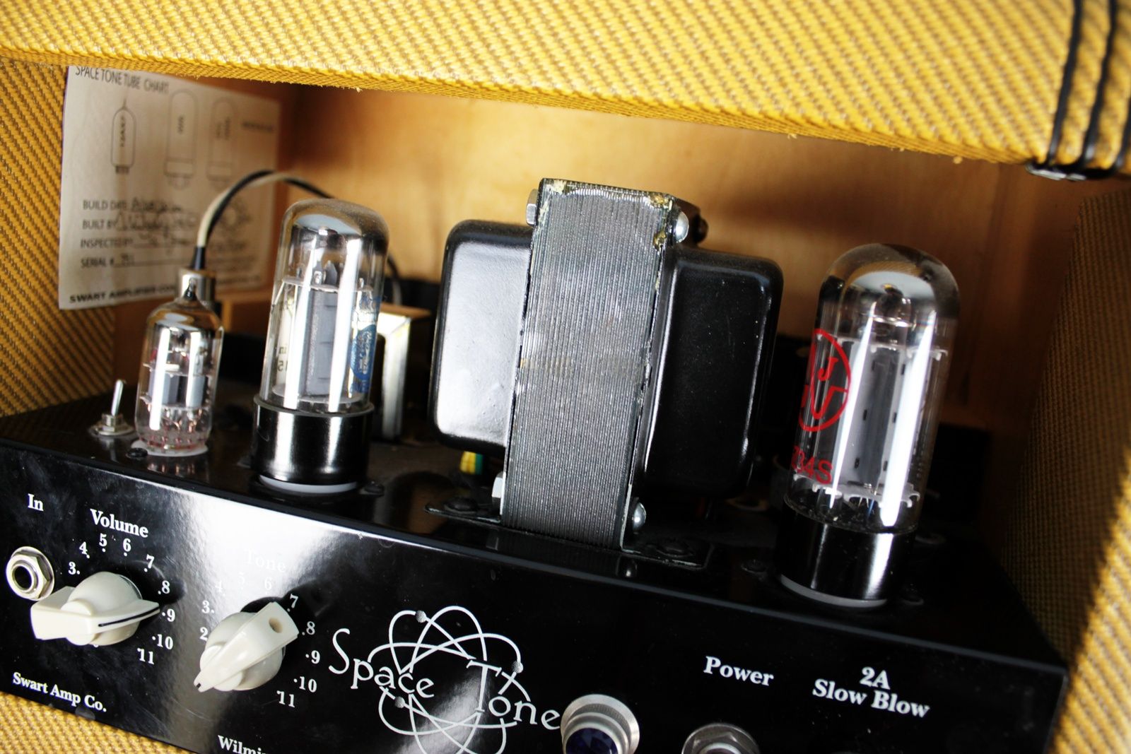 Close-up of the vacuum tubes including JJ 12AX7, JJ 6V6GT, and GZ-34 rectifier inside the cabinet.