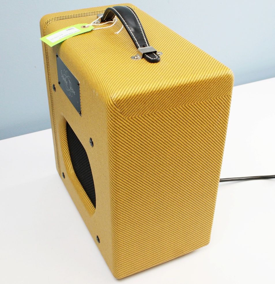 Angled front-left view of the Swart Space Tone Atomic Jr highlighting the tweed finish and finger-jointed pine cabinet.