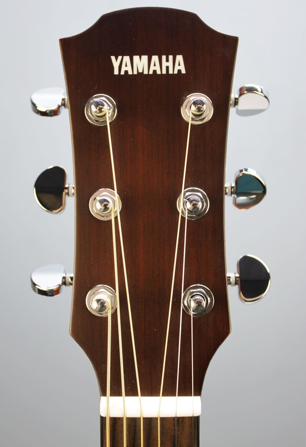 Yamaha AC1M-TBS Solid Sitka Spruce/Mahogany Concert Cutaway with Electronics - Tobacco Brown Sunburst front facing headstock