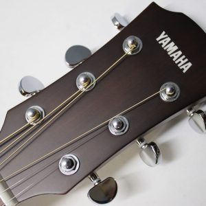 Yamaha AC1M-TBS Solid Sitka Spruce/Mahogany Concert Cutaway with Electronics - Tobacco Brown Sunburst front of headstock