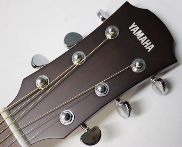 Yamaha AC1M-TBS Solid Sitka Spruce/Mahogany Concert Cutaway with Electronics - Tobacco Brown Sunburst front of headstock