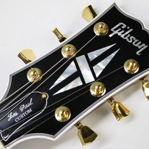 Gibson, Les Paul Custom, Les Paul Custom 70s, Gibson Les Paul Custom, Wine Red, 2025 Gibson, electric guitar, solid body guitar, mahogany body, maple top, set neck, 70s profile neck, volute neck, ebony fingerboard, nitrocellulose lacquer, dual humbuckers, gold hardware, rock guitar, blues guitar, hard rock, classic rock, premium electric guitar, USA made guitar, Gibson USA, 6 string guitar, carved maple top, wine red finish, custom series, Les Paul electric, vintage style guitar, modern classic guitar