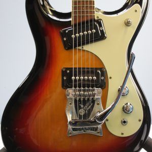 Mosrite, Ventures Model, Mk I, Fillmore, early 2000s, Sunburst, upgraded electronics, upgraded tremolo arm, vintage style guitar, offset electric guitar, surf rock guitar, collectible guitar, rare Mosrite, Japanese guitar, retro guitar, tremolo bridge, bolt-on neck, dual pickup guitar, classic sunburst finish, vintage inspired, player grade guitar, modded Mosrite, Ventures guitar, surf music, electric guitar, preowned guitar, stage ready guitar