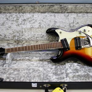 Mosrite, Ventures Model, Mk I, Fillmore, early 2000s, Sunburst, upgraded electronics, upgraded tremolo arm, vintage style guitar, offset electric guitar, surf rock guitar, collectible guitar, rare Mosrite, Japanese guitar, retro guitar, tremolo bridge, bolt-on neck, dual pickup guitar, classic sunburst finish, vintage inspired, player grade guitar, modded Mosrite, Ventures guitar, surf music, electric guitar, preowned guitar, stage ready guitar