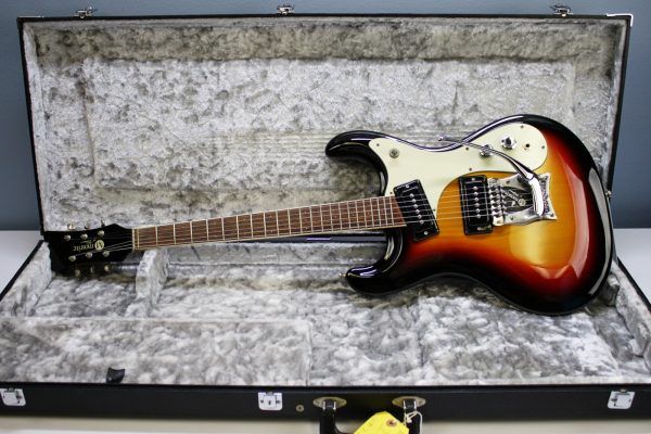 Mosrite, Ventures Model, Mk I, Fillmore, early 2000s, Sunburst, upgraded electronics, upgraded tremolo arm, vintage style guitar, offset electric guitar, surf rock guitar, collectible guitar, rare Mosrite, Japanese guitar, retro guitar, tremolo bridge, bolt-on neck, dual pickup guitar, classic sunburst finish, vintage inspired, player grade guitar, modded Mosrite, Ventures guitar, surf music, electric guitar, preowned guitar, stage ready guitar