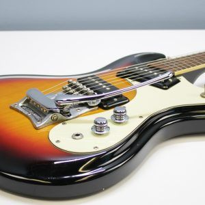 Mosrite, Ventures Model, Mk I, Fillmore, early 2000s, Sunburst, upgraded electronics, upgraded tremolo arm, vintage style guitar, offset electric guitar, surf rock guitar, collectible guitar, rare Mosrite, Japanese guitar, retro guitar, tremolo bridge, bolt-on neck, dual pickup guitar, classic sunburst finish, vintage inspired, player grade guitar, modded Mosrite, Ventures guitar, surf music, electric guitar, preowned guitar, stage ready guitar