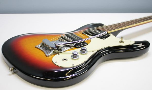 Mosrite, Ventures Model, Mk I, Fillmore, early 2000s, Sunburst, upgraded electronics, upgraded tremolo arm, vintage style guitar, offset electric guitar, surf rock guitar, collectible guitar, rare Mosrite, Japanese guitar, retro guitar, tremolo bridge, bolt-on neck, dual pickup guitar, classic sunburst finish, vintage inspired, player grade guitar, modded Mosrite, Ventures guitar, surf music, electric guitar, preowned guitar, stage ready guitar