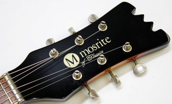 Mosrite, Ventures Model, Mk I, Fillmore, early 2000s, Sunburst, upgraded electronics, upgraded tremolo arm, vintage style guitar, offset electric guitar, surf rock guitar, collectible guitar, rare Mosrite, Japanese guitar, retro guitar, tremolo bridge, bolt-on neck, dual pickup guitar, classic sunburst finish, vintage inspired, player grade guitar, modded Mosrite, Ventures guitar, surf music, electric guitar, preowned guitar, stage ready guitar