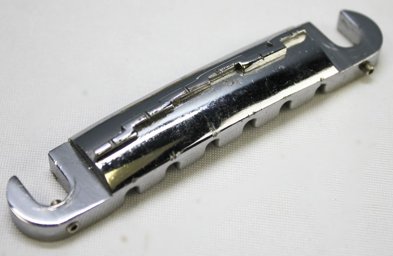 Ibanez Wrap-Around Bridge, Ibanez Bridge, Vintage Ibanez Bridge, 1970s Ibanez Parts, 70s Ibanez Hardware, Wraparound Tailpiece, Wrap Around Bridge, Gibson Melody Maker Style Bridge, Melody Maker Bridge, Vintage Guitar Bridge, Electric Guitar Bridge, Replacement Bridge, Guitar Hardware, Made in Japan Guitar Parts, MIJ Guitar Parts, Ibanez Vintage Hardware, Vintage Guitar Parts, Guitar Restoration Parts, Guitar Repair Parts, Wraparound Bridge Tailpiece, Classic Guitar Bridge, Rare Ibanez Part, Vintage MIJ Hardware, Ibanez Restoration, 1970s Guitar Hardware, Collectible Guitar Parts, Original Ibanez Part, Vintage Electric Guitar Parts, Guitar Upgrade, Luthier Parts, Bridge Assembly, Six String Guitar Bridge, Retro Guitar Hardware, Japan Vintage Guitar Parts, Ibanez Replacement Part, Vintage Wraparound Bridge, Gibson Style Bridge, Melody Maker Style Tailpiece, Guitar Bridge Upgrade, Vintage Instrument Parts, Ibanez Collectors Part